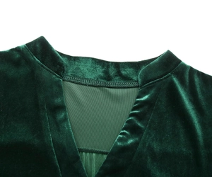 Detail of dark green velvet dress collar featuring a small V-neck and mandarin style