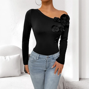 Slim fit black one-shoulder top featuring 3D floral appliques and asymmetric neckline