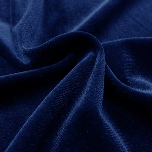Close-up of premium dark blue velvet fabric texture for women's long sleeve evening dress