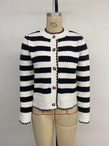 Detail of cable knit pattern and amber buttons on black and white striped cardigan