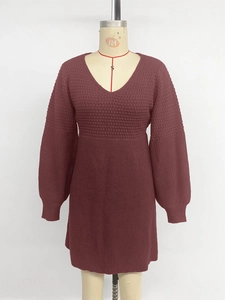 Detail of burgundy V-neck knit dress featuring waffle texture and puff lantern sleeves