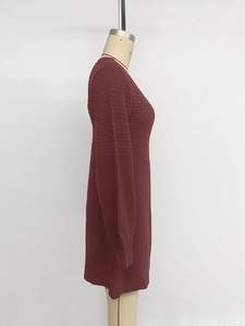 Detail of burgundy knit dress showing waffle texture and ribbed sleeve cuffs