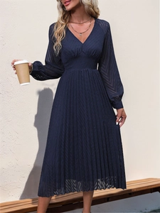 Close-up of elegant V-neck dark blue pleated maxi dress featuring textured fabric