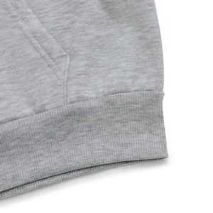 Detail of heather grey hoodie showing ribbed hem and high-quality cotton blend stitching