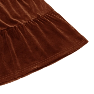 Detailed view of caramel velvet dress featuring tiered ruffled hem and durable stitching