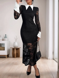 Détail de robe en dentelle noire avec col blanc contrastant et poignets à revers