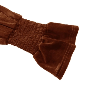 Detail of dark brown velvet sleeve with smocked elastic cuffs and ruffled wrist finish