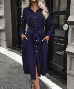 Detail view of navy blue long sleeve shirt dress with buttons, waist tie and side pockets