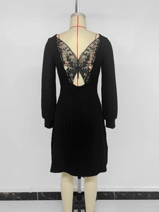 Détail d'une robe noire en maille avec dentelle en forme de papillon dans le dos