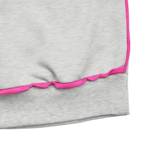Detailed close-up of grey marl knit fabric with hot pink contrast trim and ribbed cuff