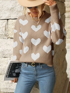 Detail view of khaki knit sweater with white heart jacquard and ribbed crew neckline
