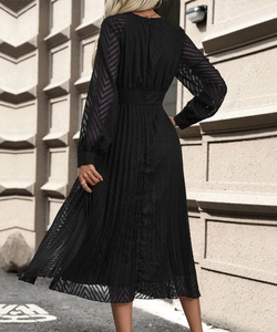 Rear view of black V-neck pleated dress featuring elegant lace sleeves and waist detail