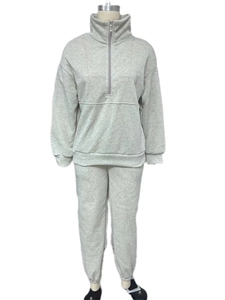 Detail view of light grey two-piece tracksuit with half-zip sweatshirt and joggers set