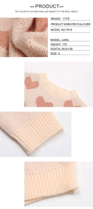 Close-up of pink heart jacquard knit texture and ribbed neckline of the sweater