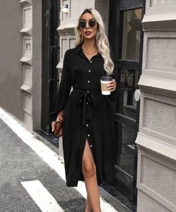 Detail of a black midi shirt dress featuring a waist tie and single-breasted buttons