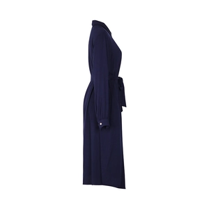 Detail of navy blue shirt dress featuring a self-tie waist belt and gold buttons on cuffs