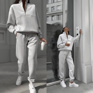 Detail of light grey ribbed knit cuffs and collar on half-zip urban tracksuit set