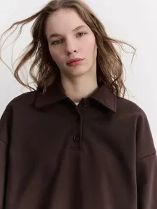 Detail of dark brown polo sweatshirt featuring a classic collar and button placket