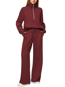 Detail of burgundy half-zip sweatshirt with kangaroo pocket and wide-leg sweatpants