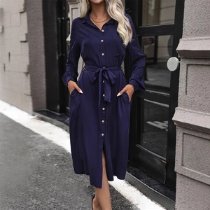 Navy blue long sleeve button-down shirt dress with waist tie in a street style shot