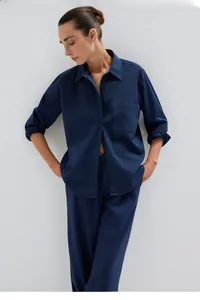 Detail of navy blue long sleeve button-down shirt set with breathable woven texture