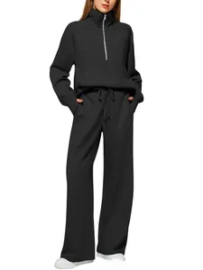 Detail of high-waist drawstring trousers and kangaroo pocket on black tracksuit