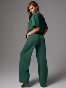 Detail of loose dark green two-piece set featuring round neck top and wide-leg pants
