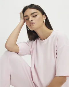 Close-up of soft pink fabric texture and stitching on the women casual short sleeve set