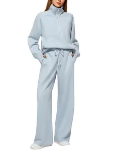 Detail of light blue two-piece tracksuit with half-zip hoodie and wide-leg drawstring pants