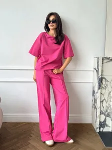 Detail of hot pink casual two-piece set featuring short sleeve top and pleated wide-leg pants