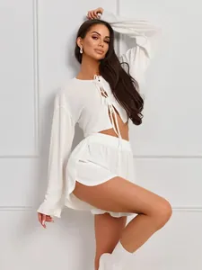 Detail view of the breathable waffle texture and lace-up closure on the white pajamas set