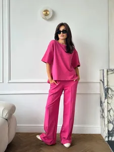 Detail view of pink loose-fit short sleeve top and wide-leg trousers casual two-piece set