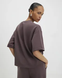 Detail of loose fit two-piece sport set in dark purple thick knitted fabric for women