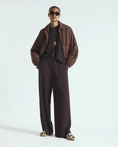 Detail of dark brown short sleeve top and loose wide leg pants with drawstring waist