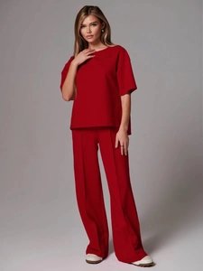 Women's chic vibrant red two-piece lounge set with round neck top and wide-leg trousers