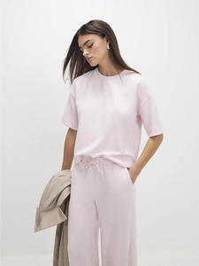 Women's pale pink two-piece set featuring short sleeve t-shirt and wide-leg trousers