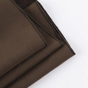 Detailed close-up of coffee brown fabric texture and high-density flat seam stitching