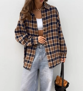 Close-up of brown and blue plaid shirt featuring high-quality cotton fabric texture