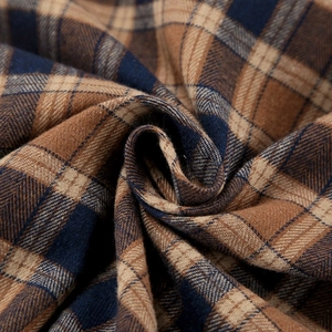 Macro detail of soft brushed plaid fabric in navy and brown for checkered shirts