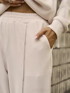 Detail of high-waist elastic waistband and pocket on beige ribbed knit lounge set