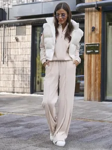 Detail of women's casual 3-piece set featuring a white vest and beige wide-leg pants