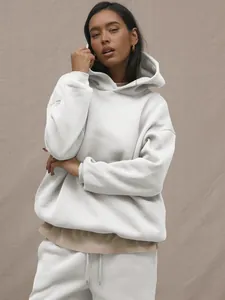 Detail of light grey oversized hoodie and drawstring sweatpants with layered inner tee