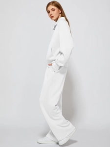 Full side view of a white two-piece tracksuit featuring a stand collar and wide-leg pants