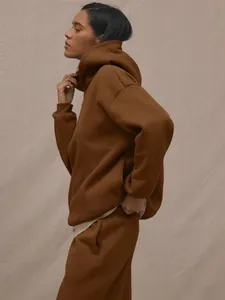 Side view of dark brown oversized hoodie and matching joggers in thick cotton blend