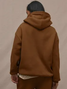 Detail of the back of a brown oversized hooded tracksuit showing high-quality cotton fabric