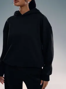Detail of a casual black oversized hoodie with dropped shoulders and thick textured fabric