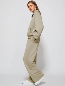 Side view of beige half-zip sweatshirt and matching wide-leg trousers set with drape effect