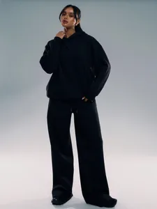 Close-up of black two-piece tracksuit with drawstring waist and soft cotton texture