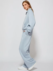 Detail of light blue two-piece lounge set featuring a sweatshirt and wide-leg sports pants