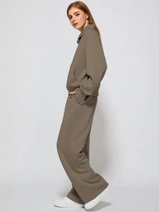 Detail view of khaki casual two-piece tracksuit featuring zip-up top and wide-leg trousers